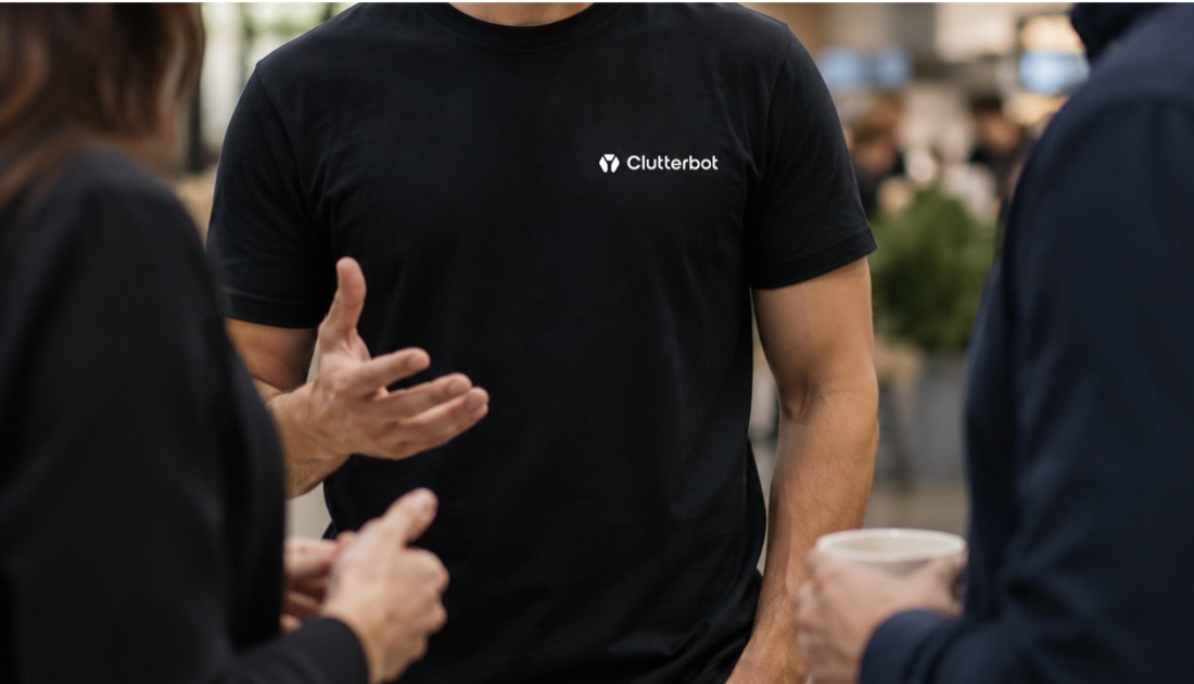 A Clutterbot team member in conversation with visitors