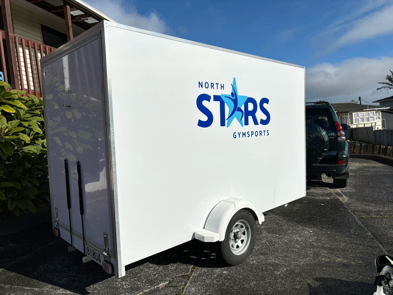 The side of the trailer with the logo applied large in blue on white